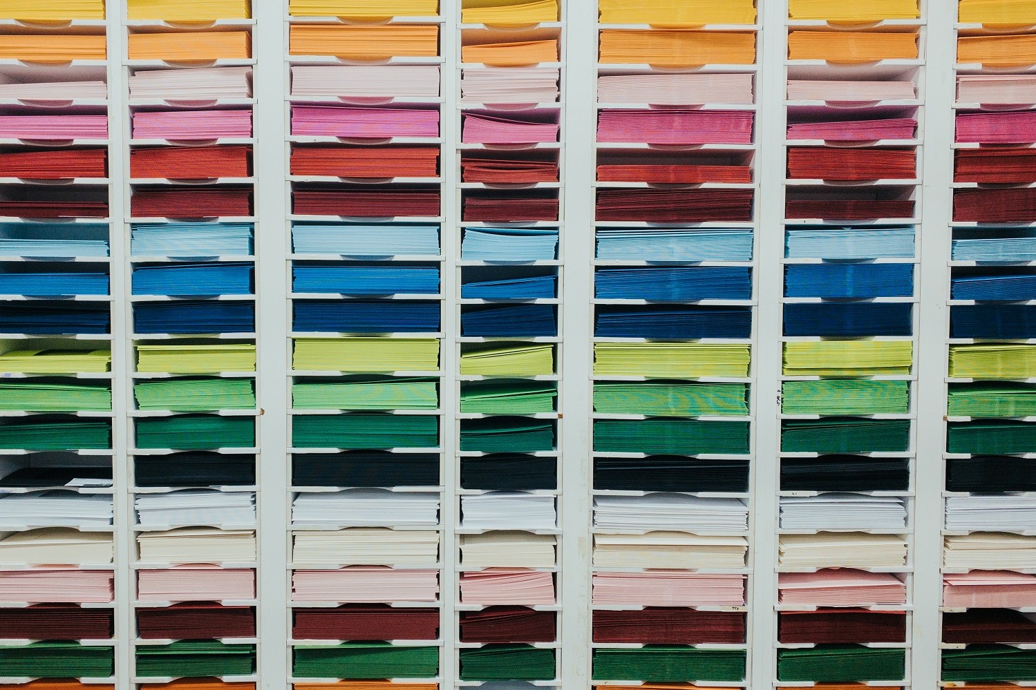 wall of different coloured paper like a rainbow