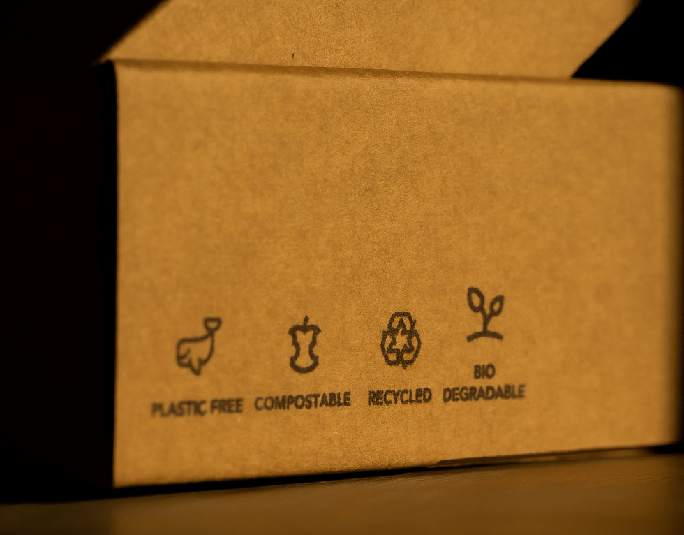 cardboard box with recycling signs on the side of it